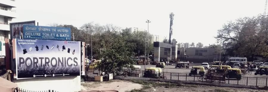 A roadside hoarding run in Delhi with traffic passing