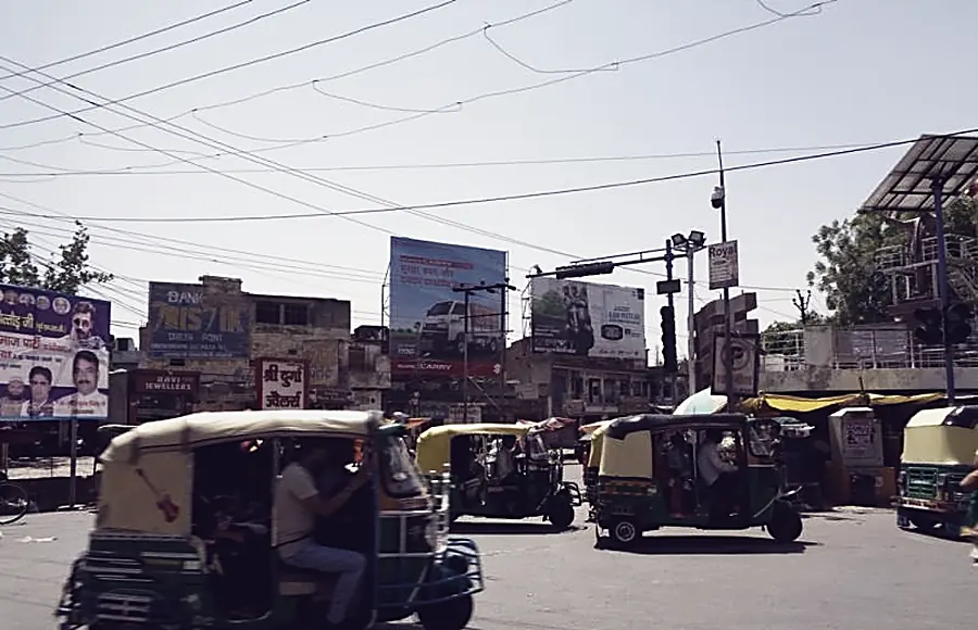 A dense Agra market street with stacked shop signage