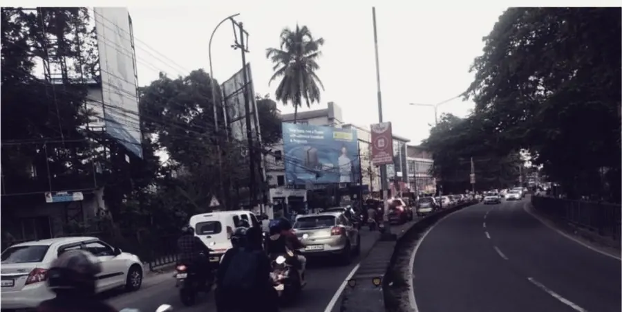 Two-wheelers and cars on a divided highway through Kochi