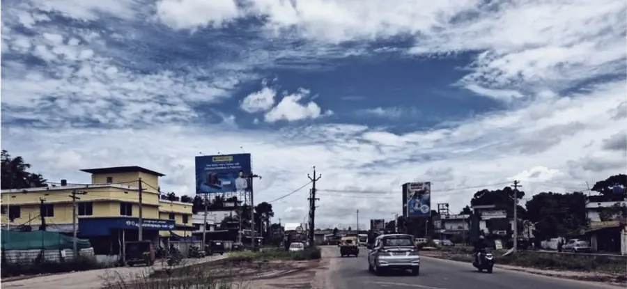 An open stretch of highway through Kochi under monsoon cloud