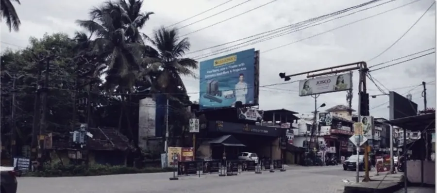 A junction in Palakkad with signage stacked above the shopfronts